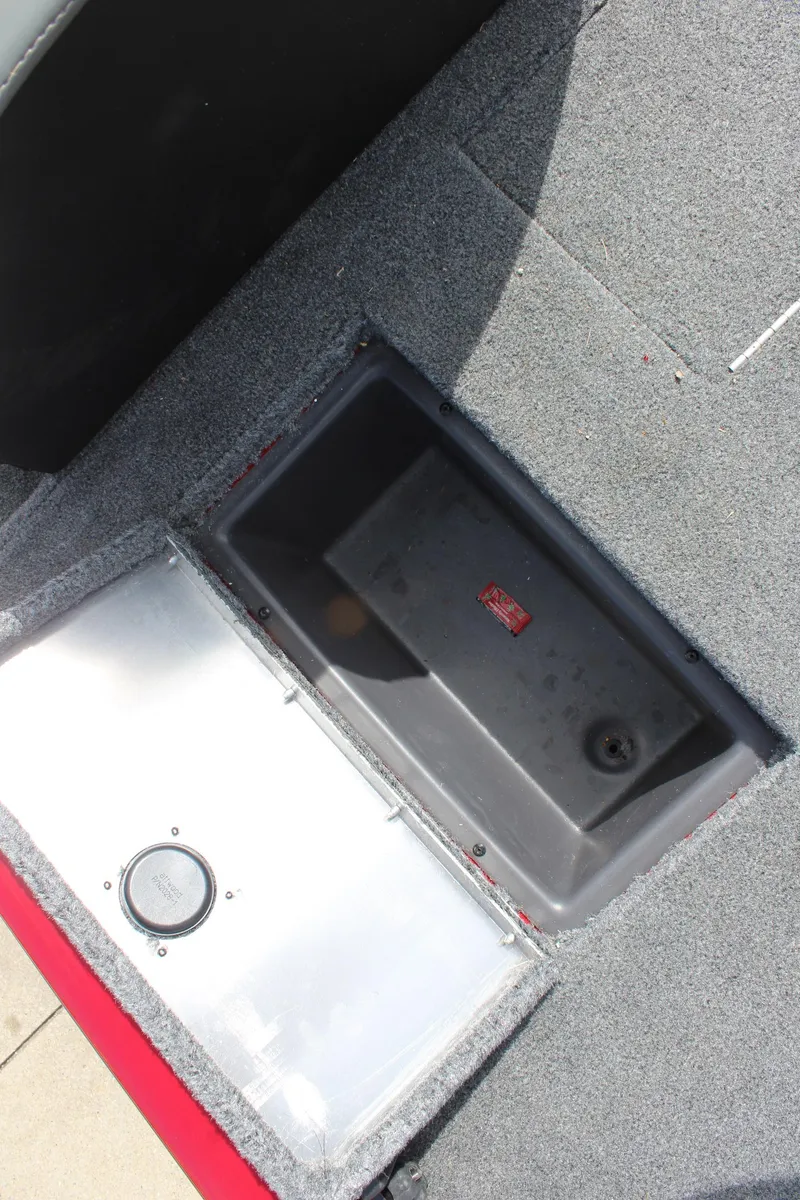 Slide: The Image of 2022 Tracker Pro Team 175 TXW boat storage compartment with carpeted interior. - 20