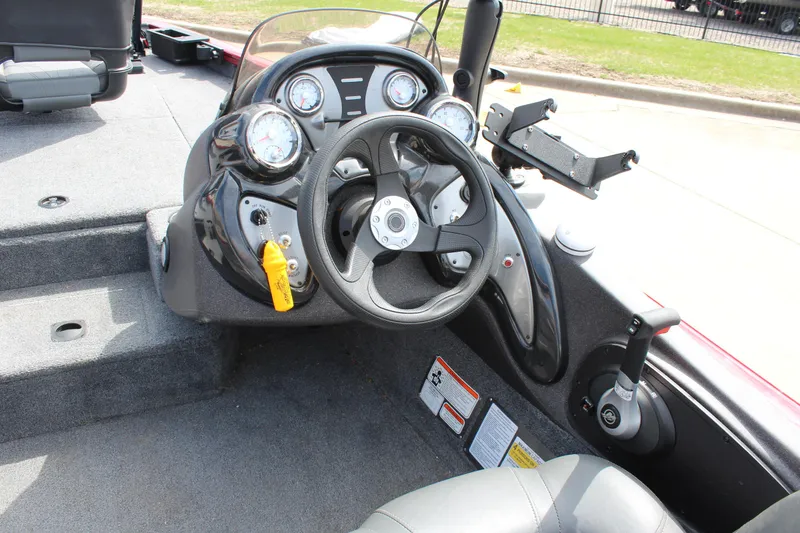 Slide: The Image of 2022 Tracker Pro Team 175 TXW boat dashboard with steering wheel and gauges. - 22
