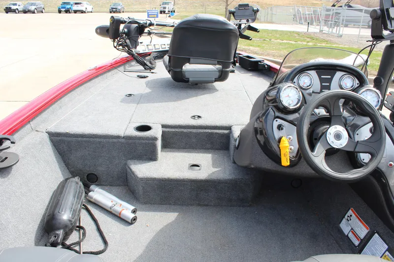 Slide: The Image of 2022 Tracker Pro Team 175 TXW boat interior with steering wheel and seating. - 23