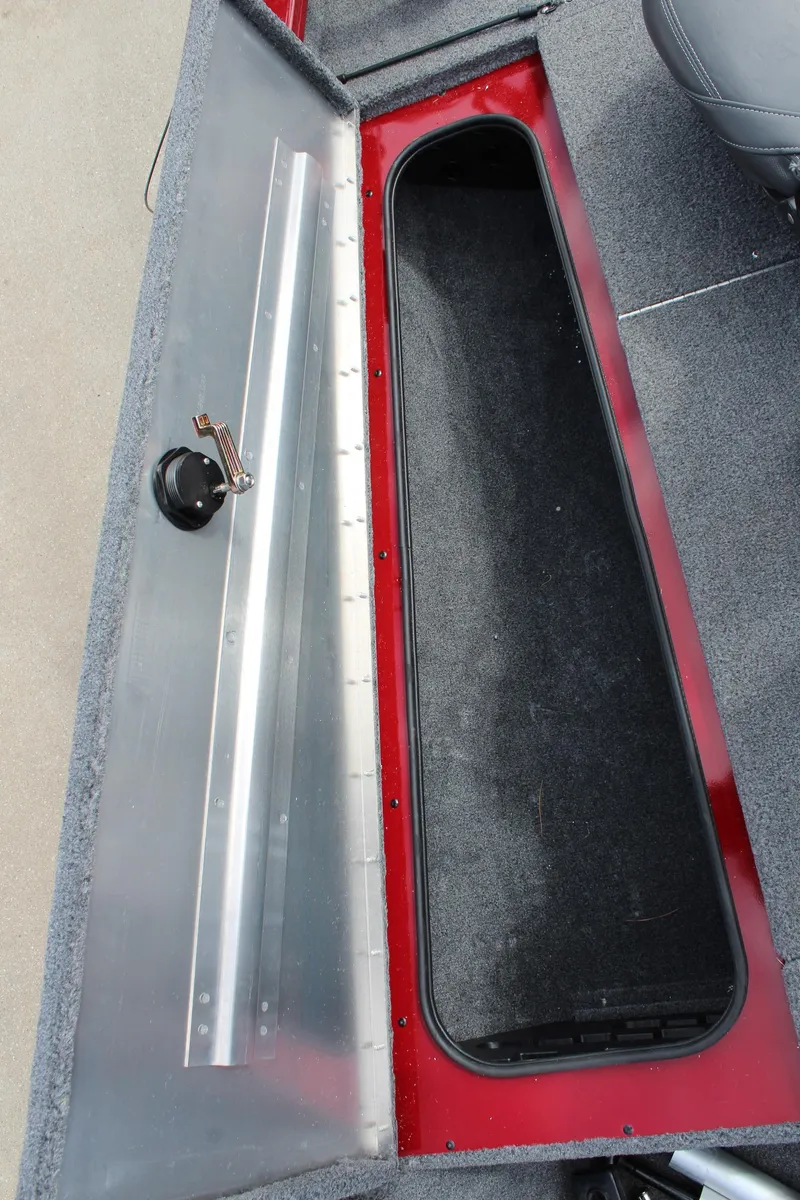 Slide: The Image of 2022 Tracker Pro Team 175 TXW boat storage compartment with open lid, showing interior space. - 26