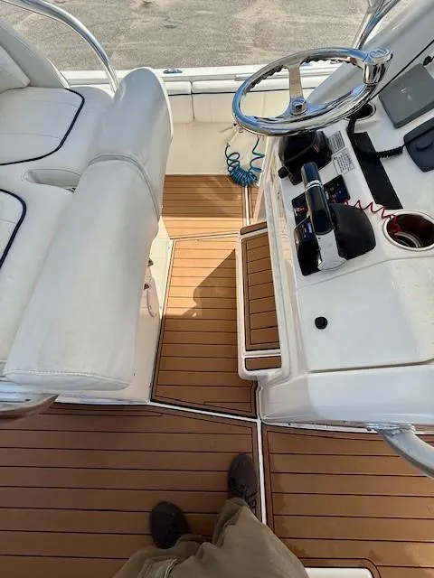 Slide: The Image of 2016 Regulator 25 boat cockpit with teak flooring and modern controls. - 13