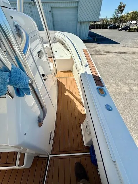 Slide: The Image of 2016 Regulator 25 boat interior with teak flooring and stainless steel features. - 14