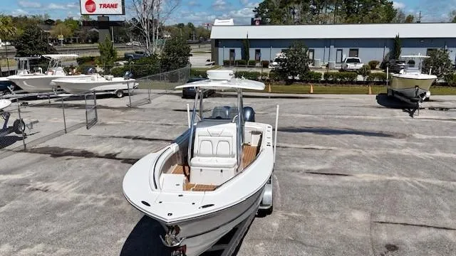 Slide: The Image of 2016 Regulator 25 boat on display in a dealership lot. - 2