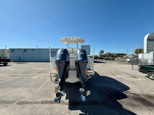 Slide: The Image of 2016 Regulator 25 boat with twin outboard engines in a parking lot. - 4