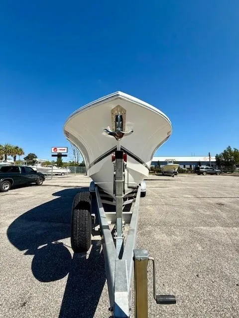 Slide: The Image of 2016 Regulator 25 boat on trailer under clear blue sky. - 6
