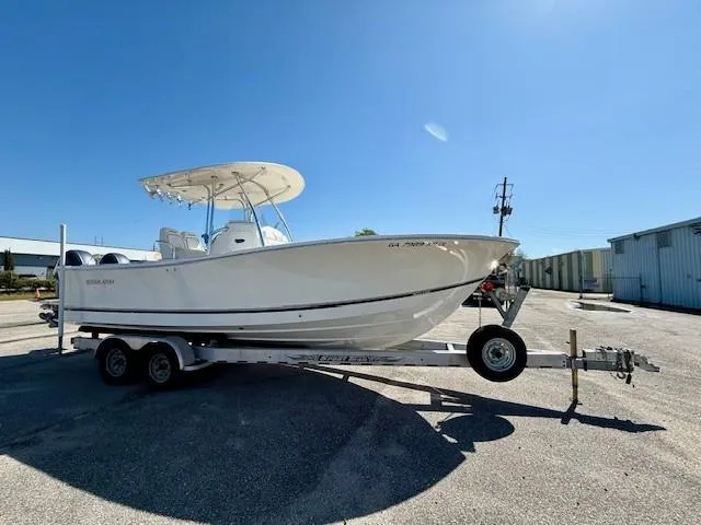 Slide: The Image of 2016 Regulator 25 boat on trailer under clear blue sky. - 7