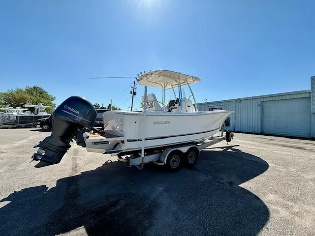 Slide: The Image of 2016 Regulator 25 boat on trailer with Yamaha outboard motor in sunny outdoor setting. - 9