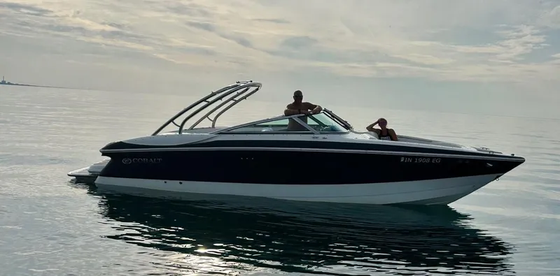 The Image of 2004 Cobalt 282 boat on calm water under cloudy sky. - 0