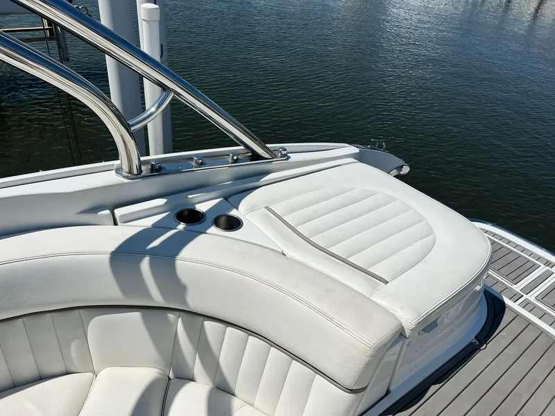 Slide: The Image of 2004 Cobalt 282 boat with white leather seating and stainless steel railings on the water. - 11