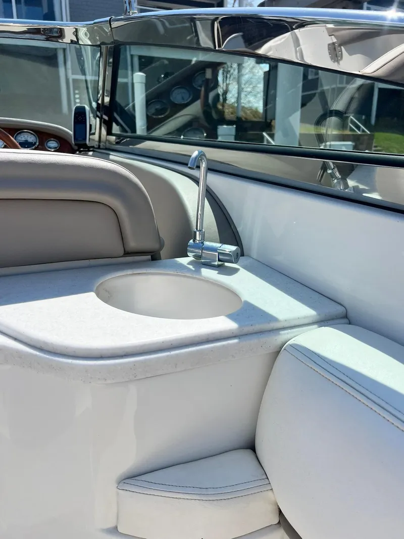 Slide: The Image of 2004 Cobalt 282 boat interior with sink and seating area. - 14