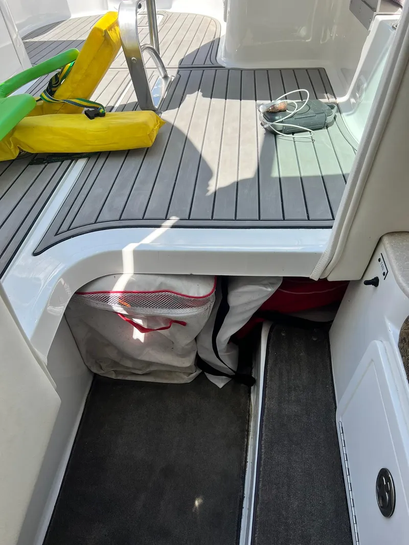 Slide: The Image of 2004 Cobalt 282 boat interior with storage, life jackets, and accessories. - 17