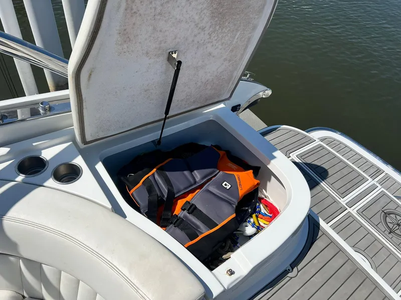 Slide: The Image of Open storage compartment on 2004 Cobalt 282 boat with life jackets and accessories. - 18