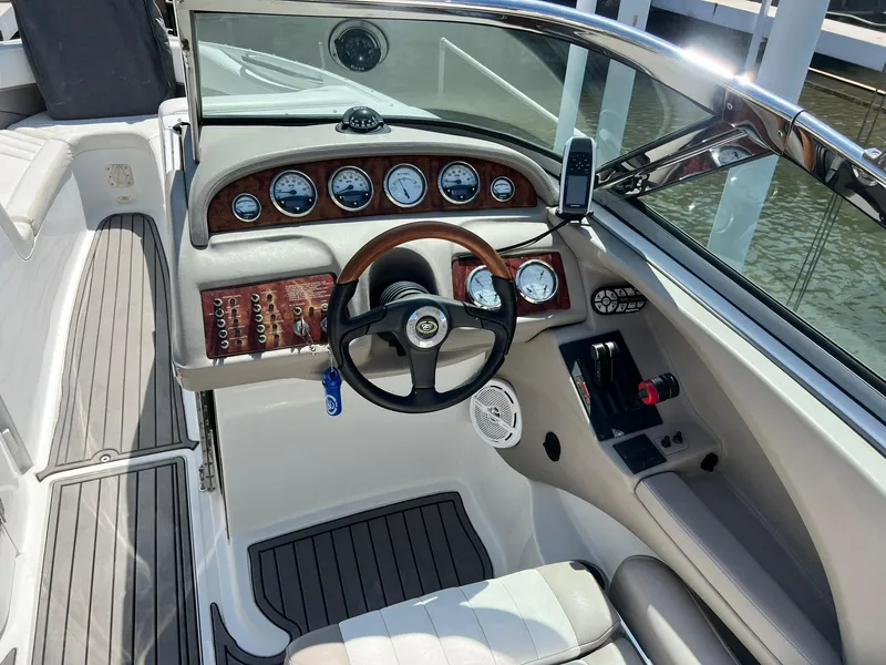 Slide: The Image of 2004 Cobalt 282 boat cockpit with steering wheel and instrument panel. - 19
