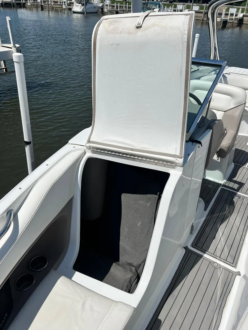 Slide: The Image of 2004 Cobalt 282 boat with open storage compartment by the water. - 23