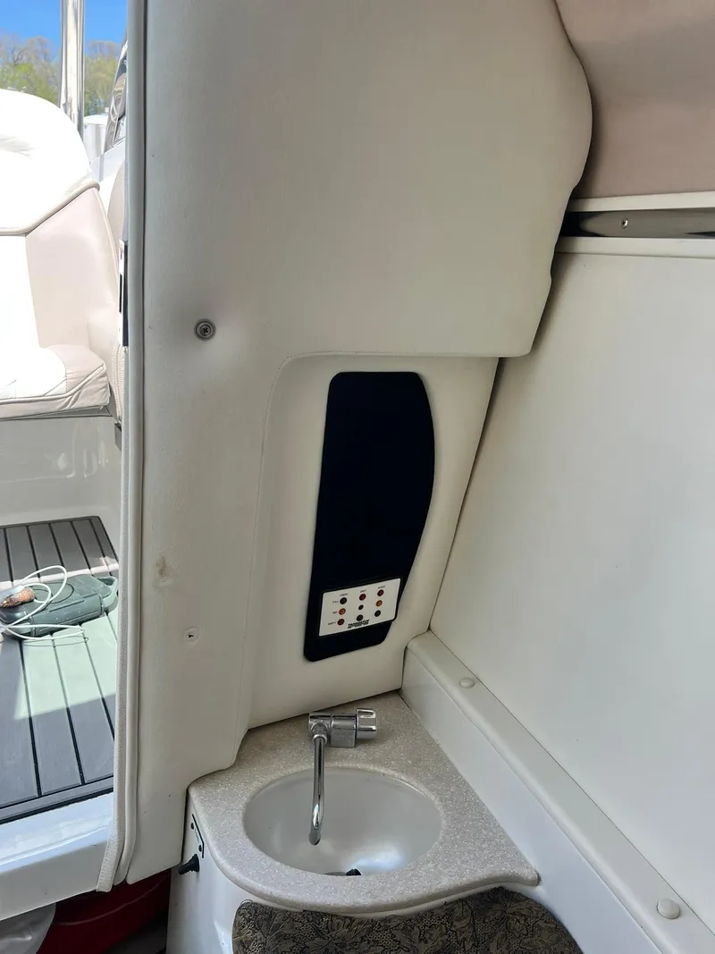 Slide: The Image of 2004 Cobalt 282 boat interior with sink and control panel. - 24