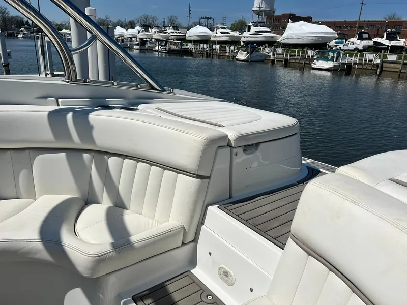 Slide: The Image of 2004 Cobalt 282 boat with white seating, docked at a marina with other boats. - 26