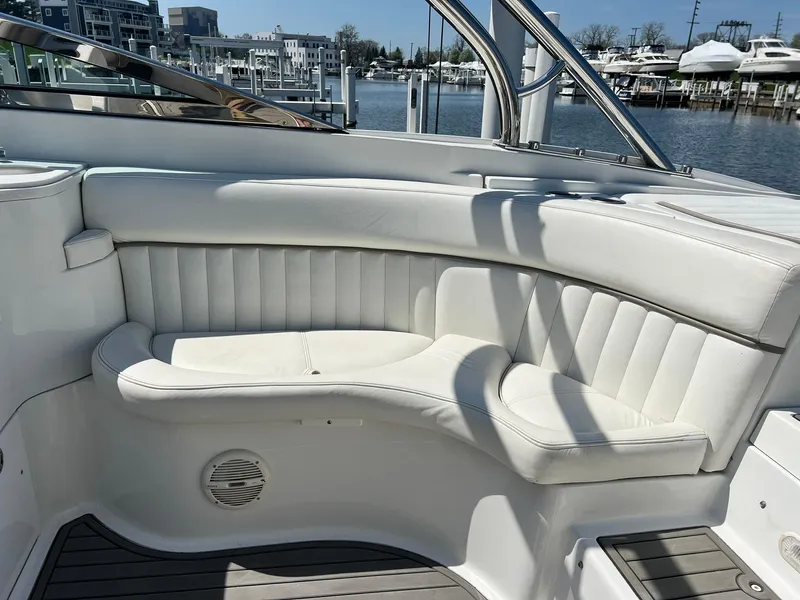Slide: The Image of 2004 Cobalt 282 boat interior with white leather seating, docked at a marina. - 3