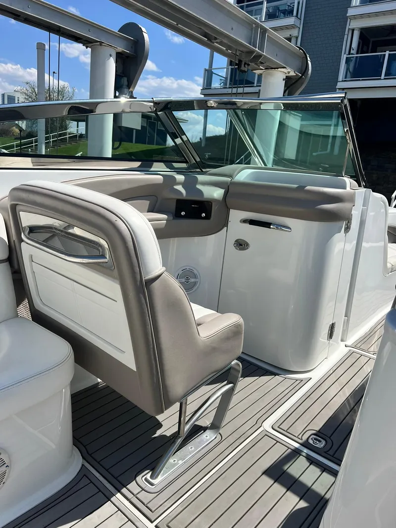 Slide: The Image of 2004 Cobalt 282 boat interior with beige seating and modern dashboard. - 31