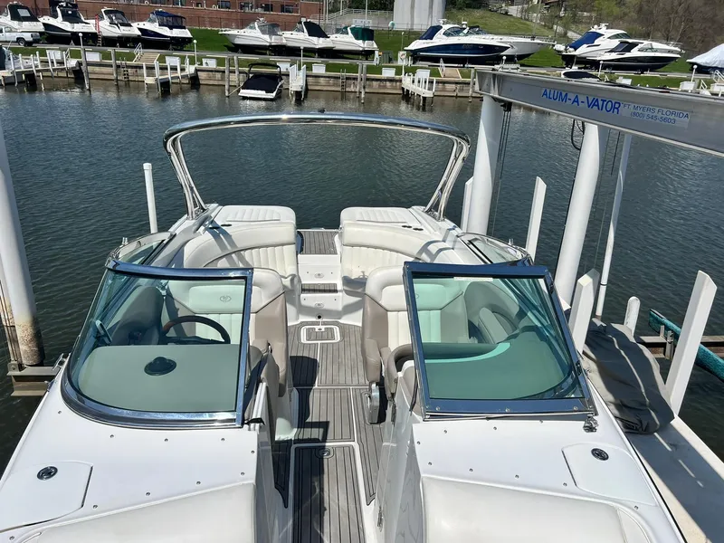 Slide: The Image of 2004 Cobalt 282 boat docked at marina, featuring spacious seating and sleek design. - 4