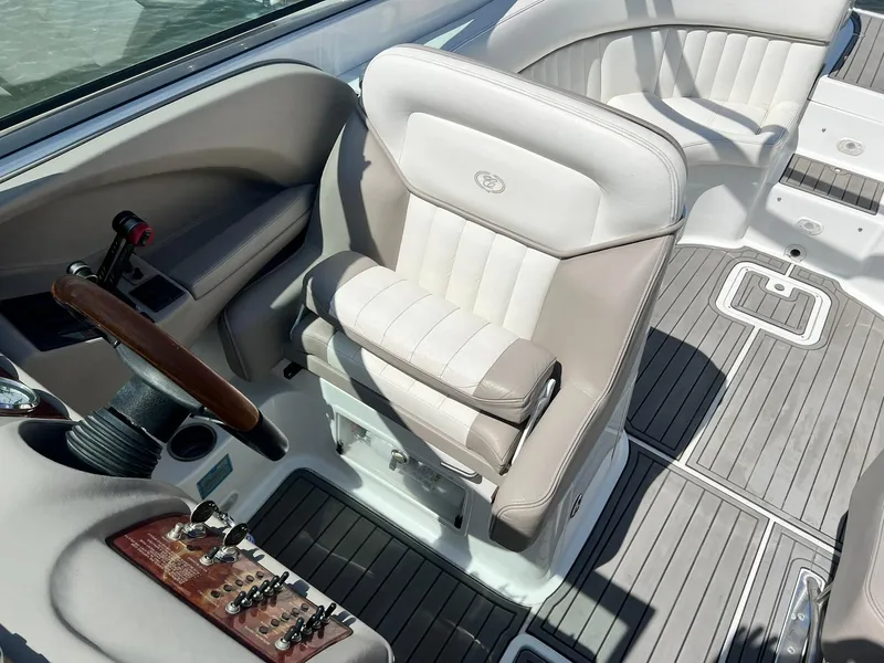 Slide: The Image of 2004 Cobalt 282 boat interior with beige seating and wood-accented controls. - 5