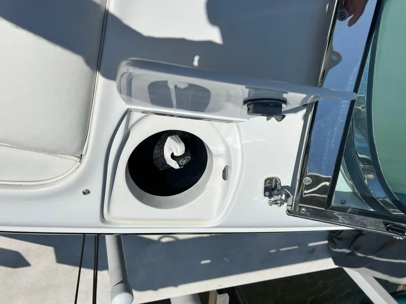 Slide: The Image of 2004 Cobalt 282 boat cup holder with a clear lid and white seating. - 6