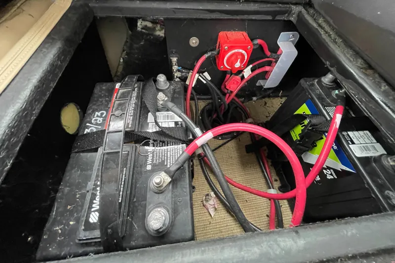Slide: The Image of Battery compartment of 2023 Harris Cruiser 230 with wiring and switch. - 17
