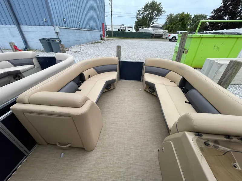 Slide: The Image of 2023 Harris Cruiser 230 pontoon boat with beige seating and spacious deck. - 30