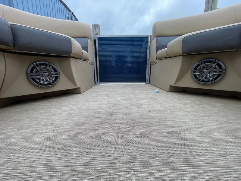 Slide: The Image of 2023 Harris Cruiser 230 interior with beige seating and marine speakers. - 38