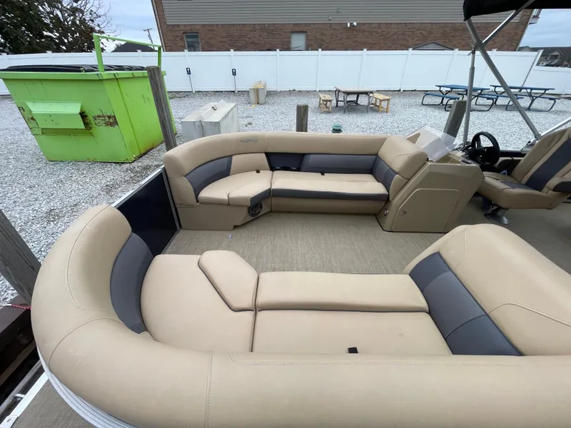 Slide: The Image of 2023 Harris Cruiser 230 boat interior with beige seating and modern design. - 4
