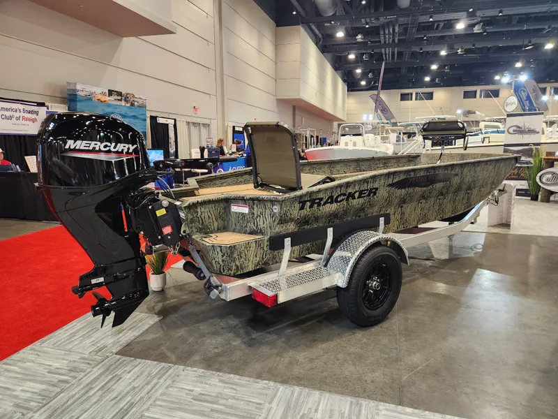 Slide: The Image of 2025 Tracker Grizzly 1650 T Prairie Wings Edition boat displayed indoors. - 2