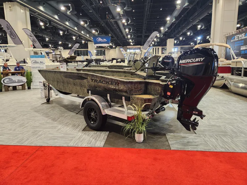 Slide: The Image of 2025 Tracker Grizzly 1650 T Prairie Wings Edition boat displayed at an indoor exhibition. - 3
