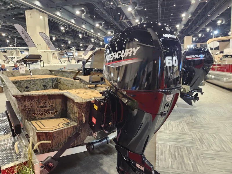 Slide: The Image of 2025 Tracker Grizzly 1650 T Prairie Wings Edition with Mercury 60 engine at a boat show. - 4