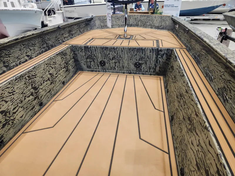 Slide: The Image of 2025 Tracker Grizzly 1650 T Prairie Wings Edition boat interior with camo design and wood accents. - 5