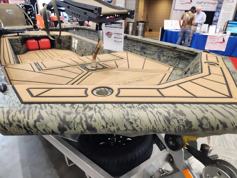 Slide: The Image of 2025 Tracker Grizzly 1650 T Prairie Wings Edition boat on display indoors. - 7