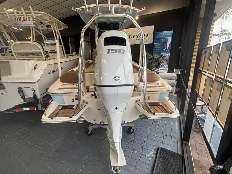 Slide: The Image of 2025 Pioneer 202 Islander boat with 150 HP engine displayed in showroom. - 1
