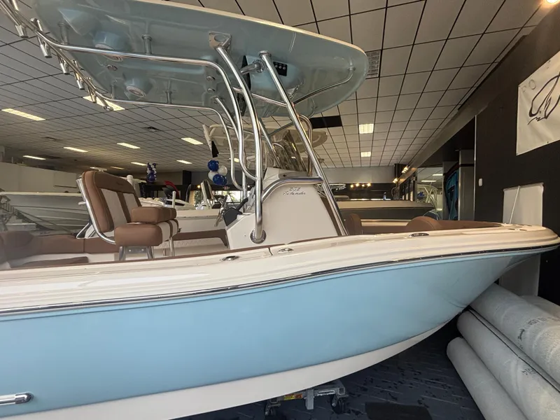 Slide: The Image of 2025 Pioneer 202 Islander boat in showroom, featuring sleek design and modern amenities. - 10