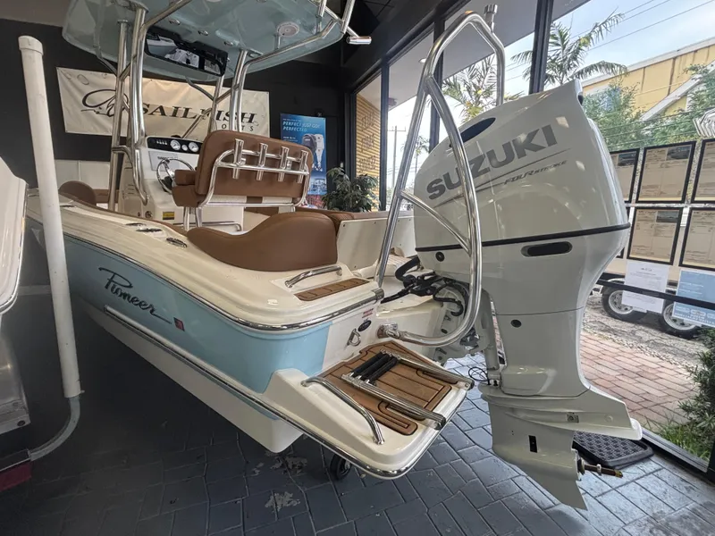 Slide: The Image of 2025 Pioneer 202 Islander boat with Suzuki outboard motor in showroom display. - 3