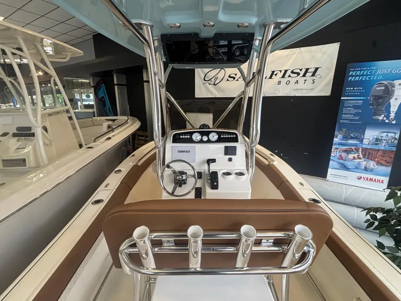 Slide: The Image of 2025 Pioneer 202 Islander boat interior with control panel and rod holders. - 4