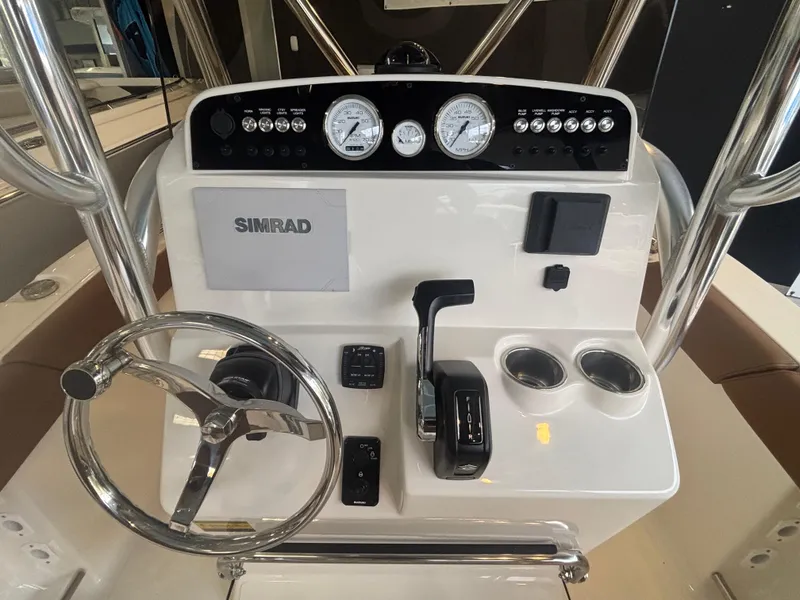 Slide: The Image of 2025 Pioneer 202 Islander boat dashboard with steering wheel, gauges, and controls. - 5