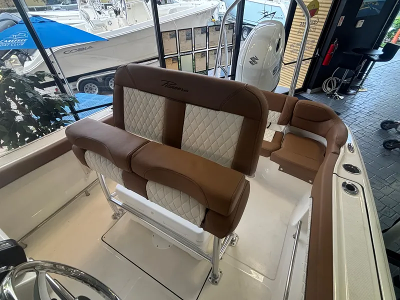 Slide: The Image of 2025 Pioneer 202 Islander boat interior with brown and white seating, showcasing modern design. - 6
