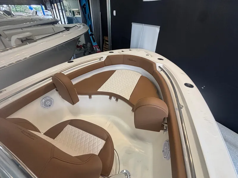 Slide: The Image of 2025 Pioneer 202 Islander boat interior with brown and white seating, showcasing modern design. - 8