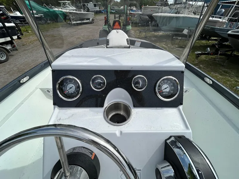 Slide: The Image of 2025 Crestliner 1800 Bay boat dashboard with gauges and steering wheel. - 10