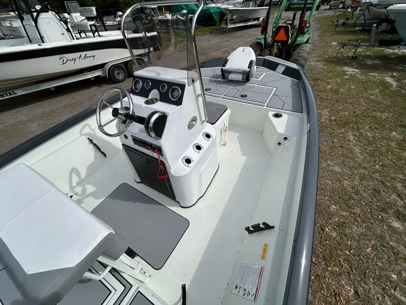 Slide: The Image of 2025 Crestliner 1800 Bay boat interior with steering console and seating. - 12
