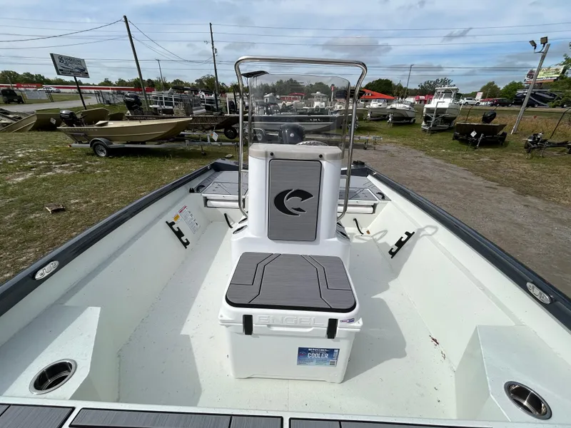 Slide: The Image of 2025 Crestliner 1800 Bay boat interior with center console and seating, displayed outdoors. - 15