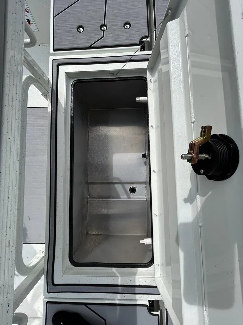Slide: The Image of 2025 Crestliner 1800 Bay boat interior storage compartment, open lid, showing spacious design. - 17