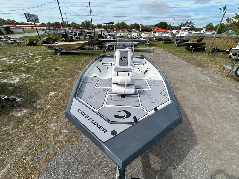 Slide: The Image of 2025 Crestliner 1800 Bay boat displayed outdoors, showcasing sleek design and spacious deck. - 6