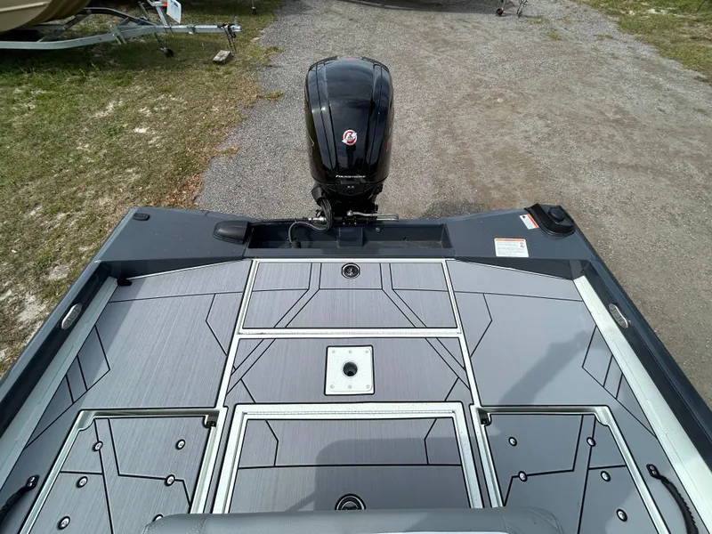 Slide: The Image of 2025 Crestliner 1800 Bay boat with sleek deck design and powerful outboard motor. - 7