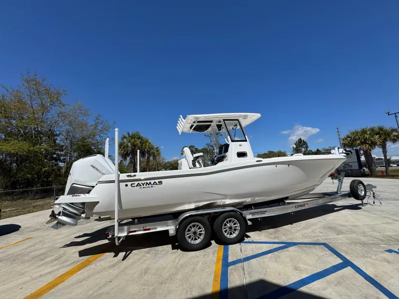Slide: The Image of 2025 Caymas 291 boat on trailer under clear blue sky. - 12