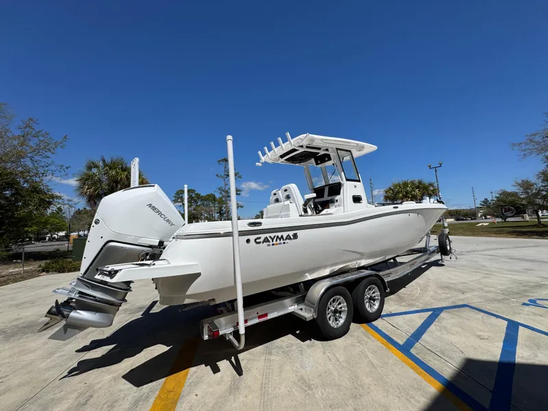 Slide: The Image of 2025 Caymas 291 boat on trailer under clear blue sky. - 13