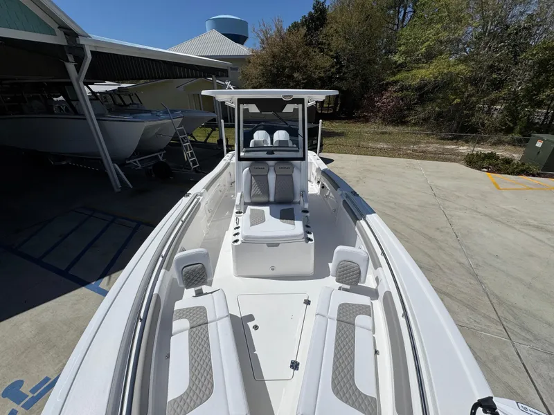 Slide: The Image of 2025 Caymas 291 boat with sleek white design, docked outdoors. - 23